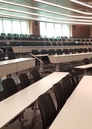 A large room with many chairs and tables.