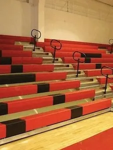 A group of red and black seats in a gym.